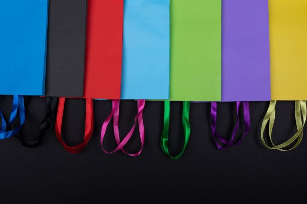 Multicoloured printed paper bags with ribbon handles